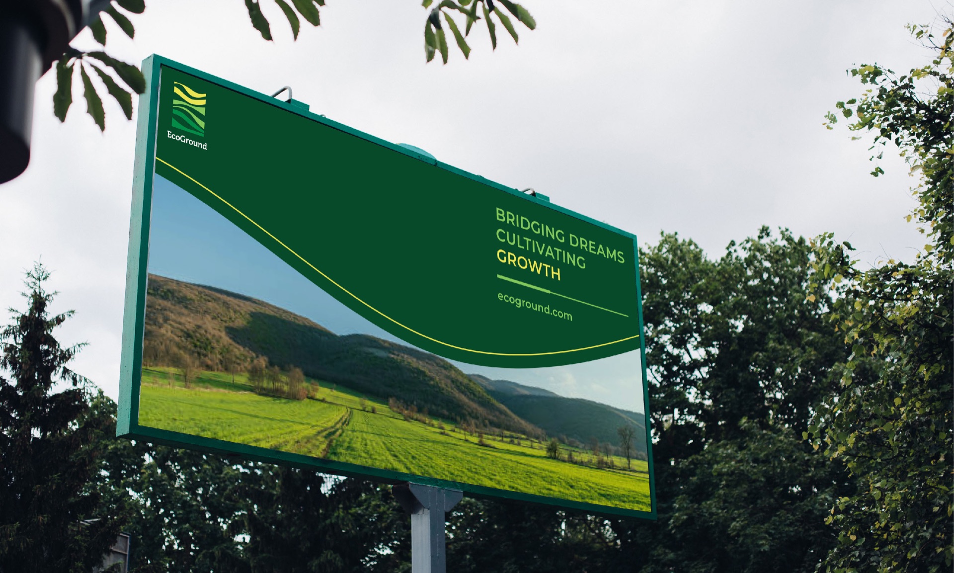 EcoGround billboard among trees with the line Bridging dreams, cultivating growth