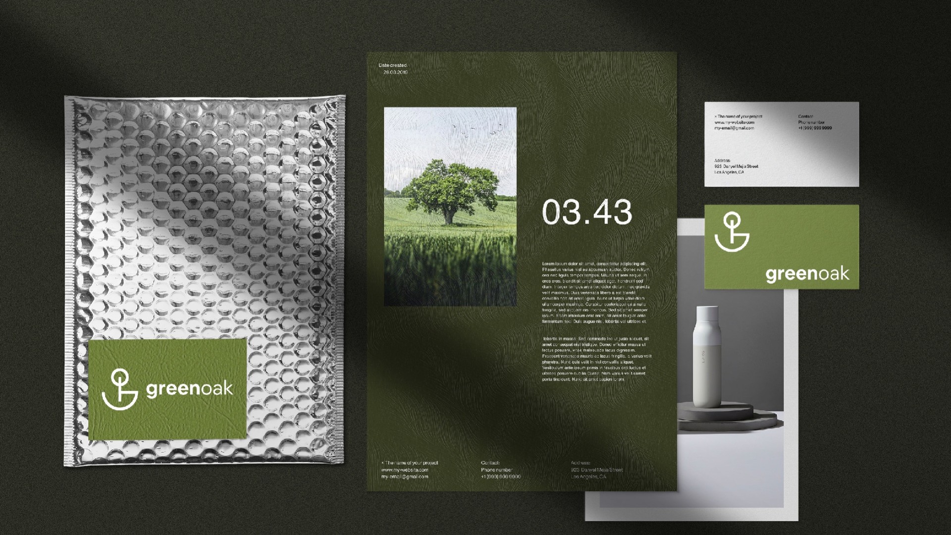 Stationery set with a bubble mailer, letterhead, business card and bottle on dark green