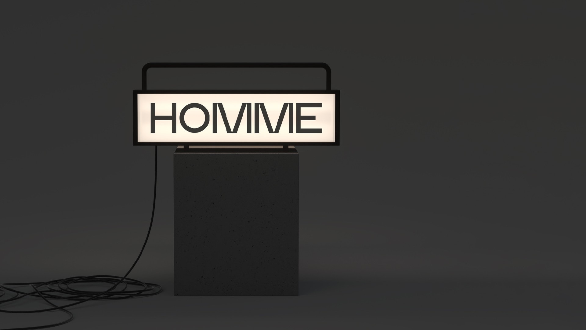 Illuminated Homme sign on a black plinth