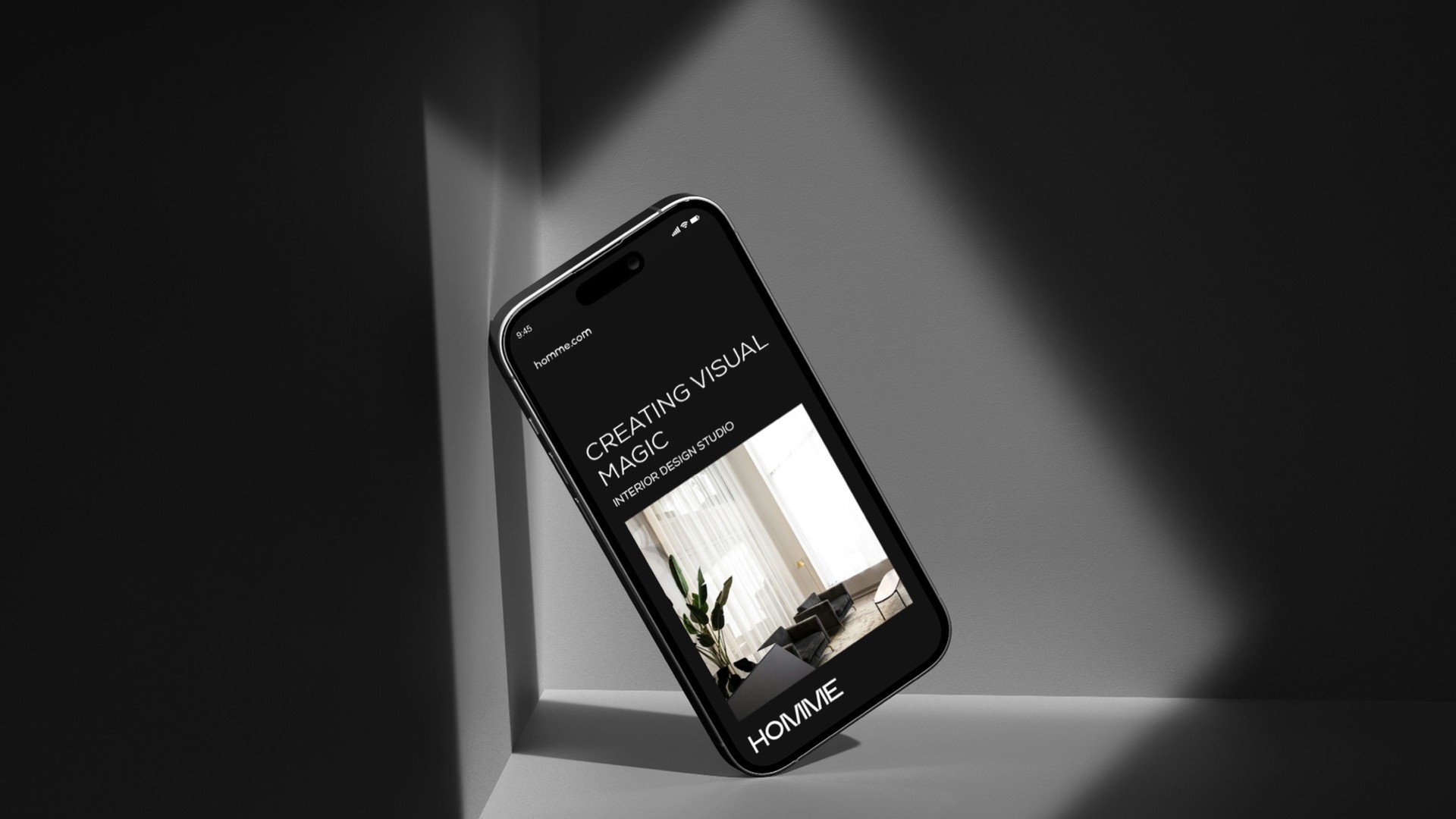 Phone showing the Homme site with the line Creating Visual Magic
