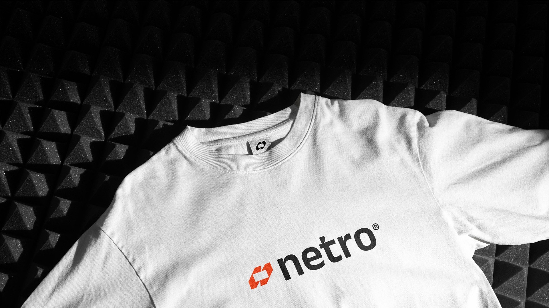 A white T-shirt with the orange and black logo