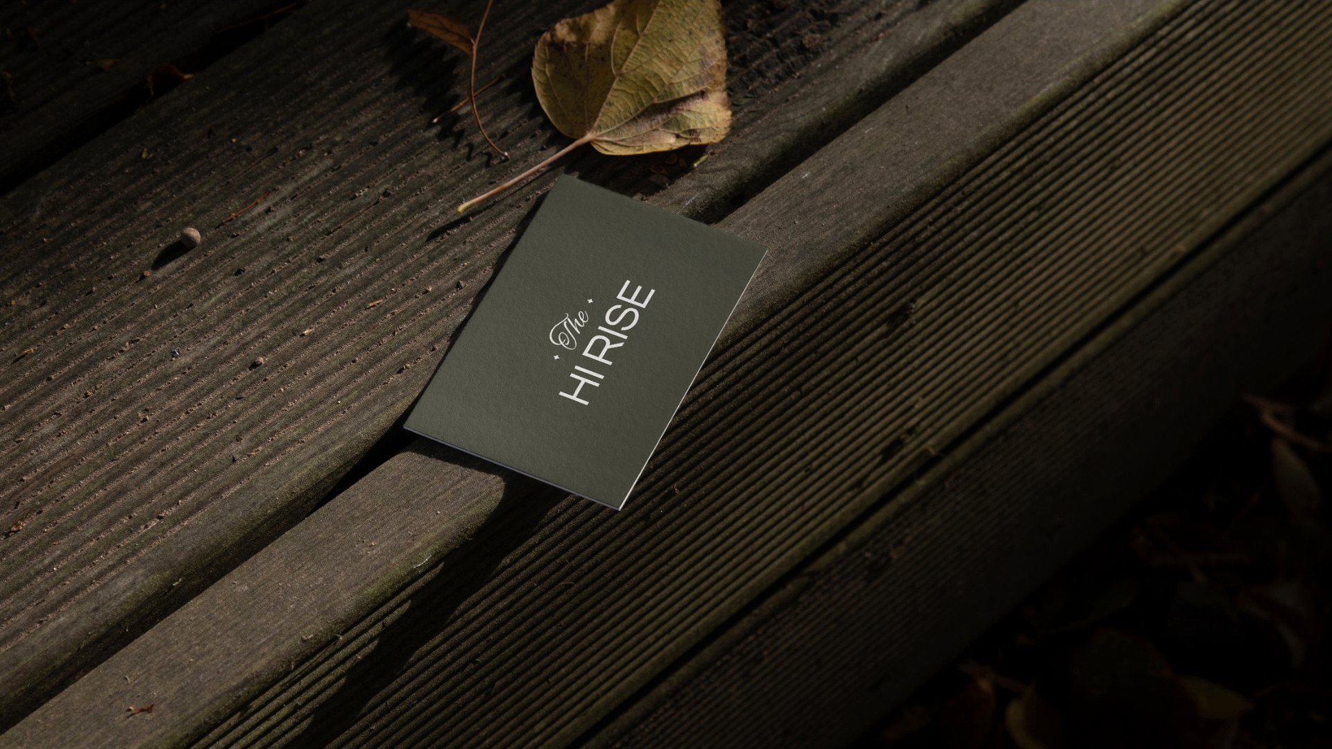 An olive key card on dark wooden steps