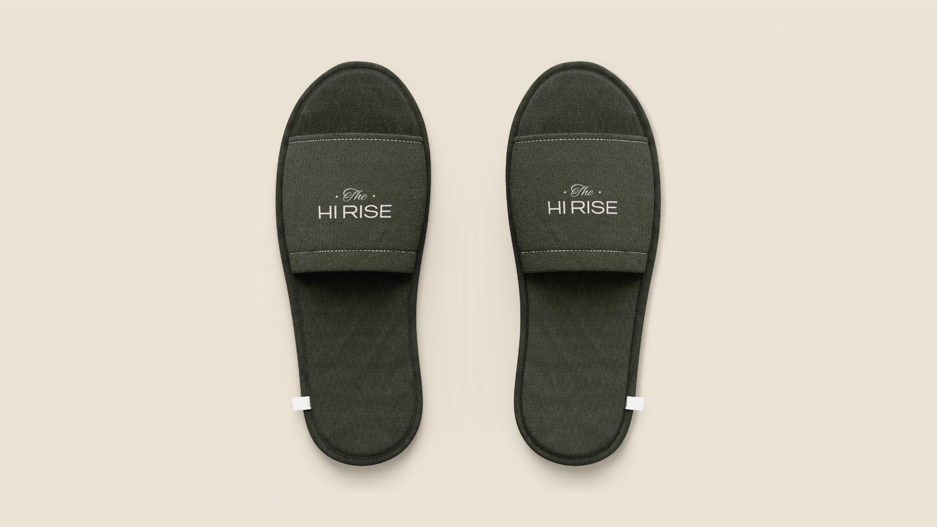 A pair of olive slippers with the logo