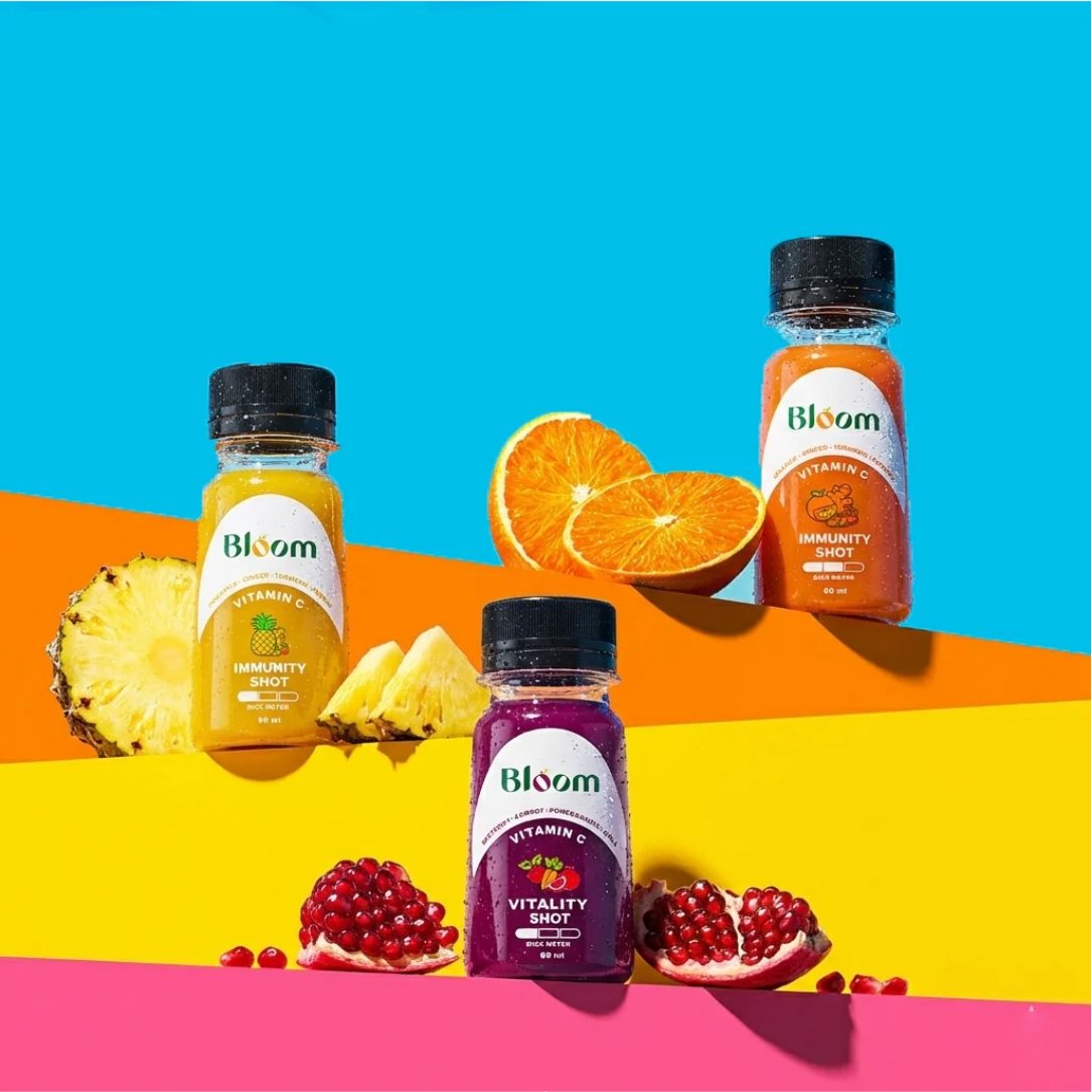 Three shots on orange, yellow and pink steps with pineapple, orange and pomegranate