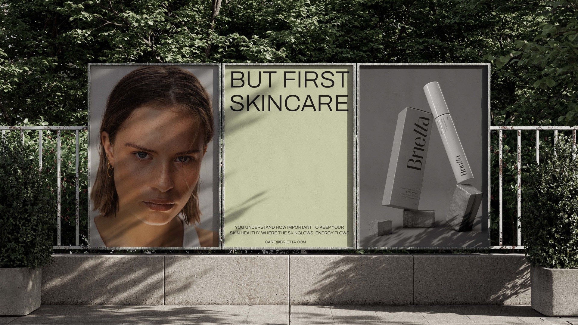 Street poster boards with a portrait, But First Skincare and a tube in a park