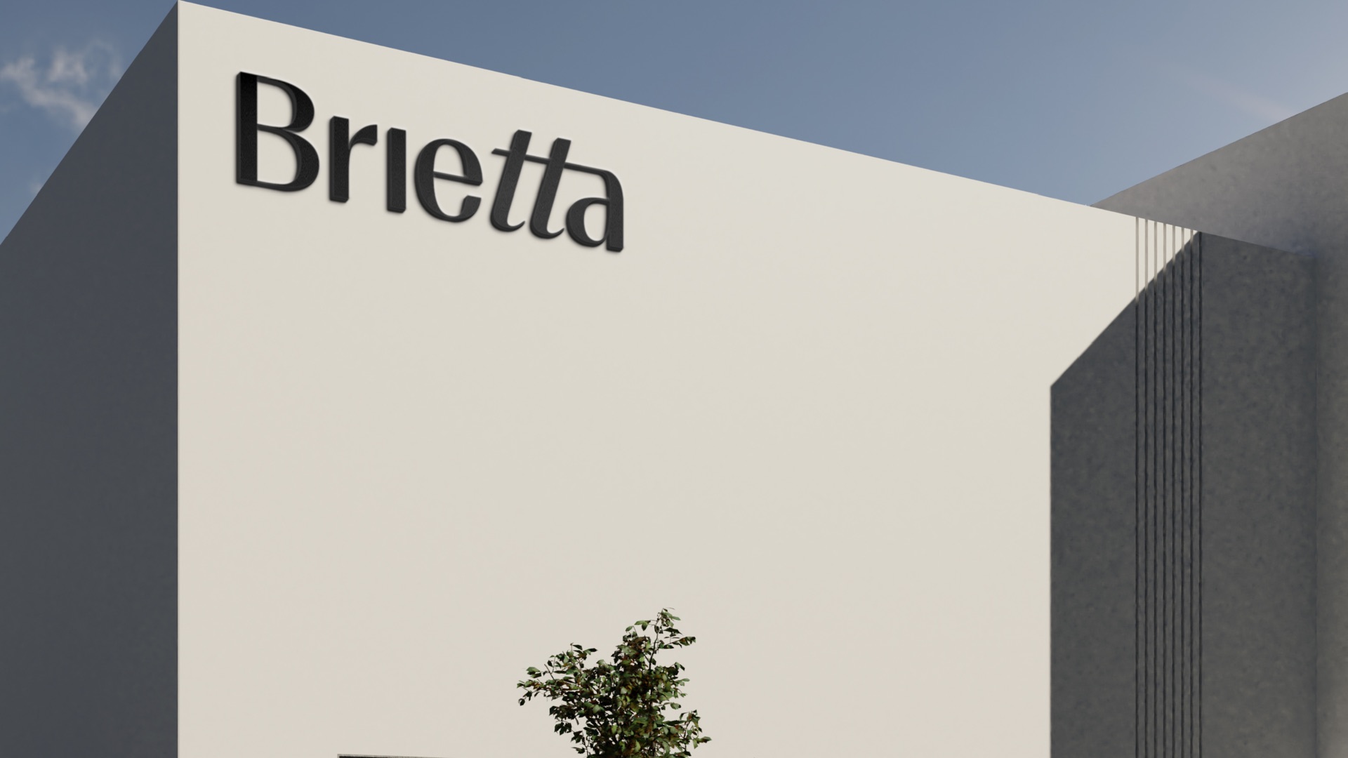The Brietta wordmark in black on a white building against a blue sky
