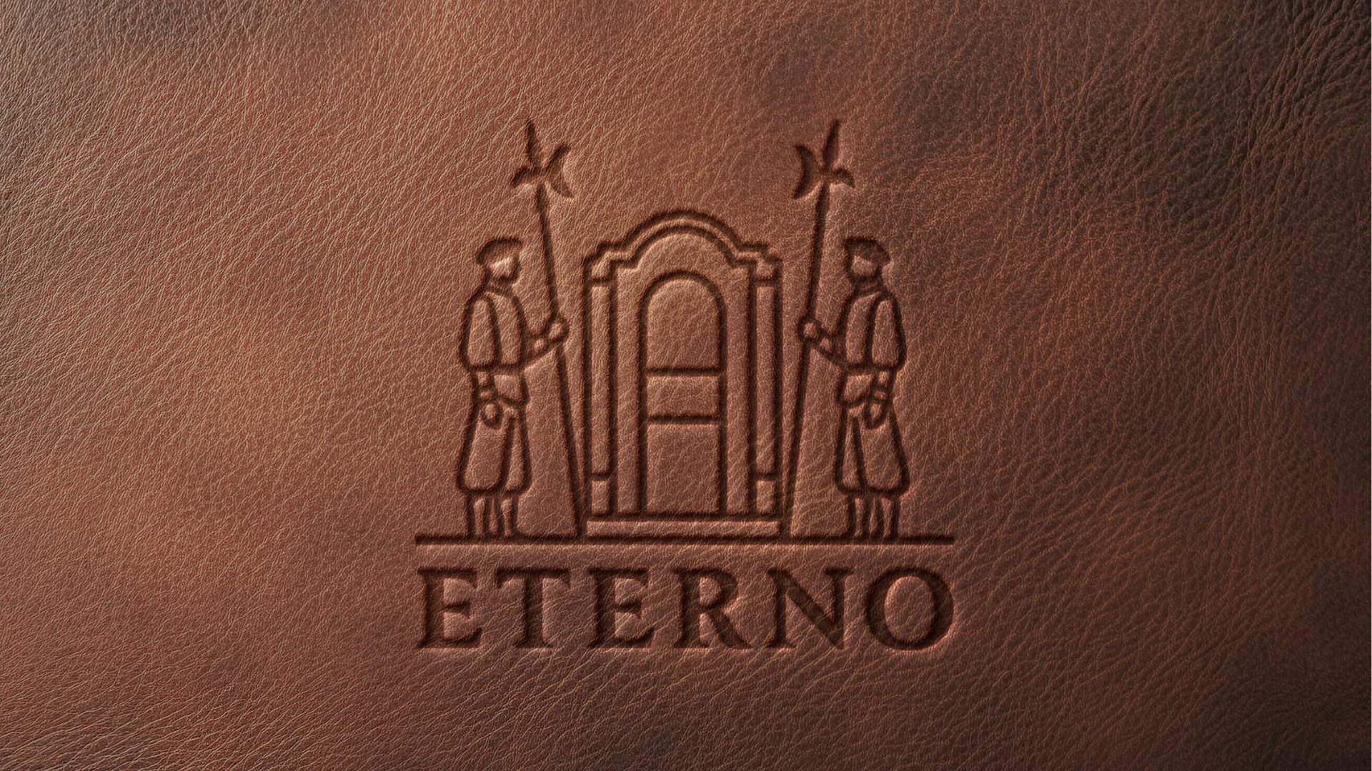 The crest and wordmark debossed into tan leather