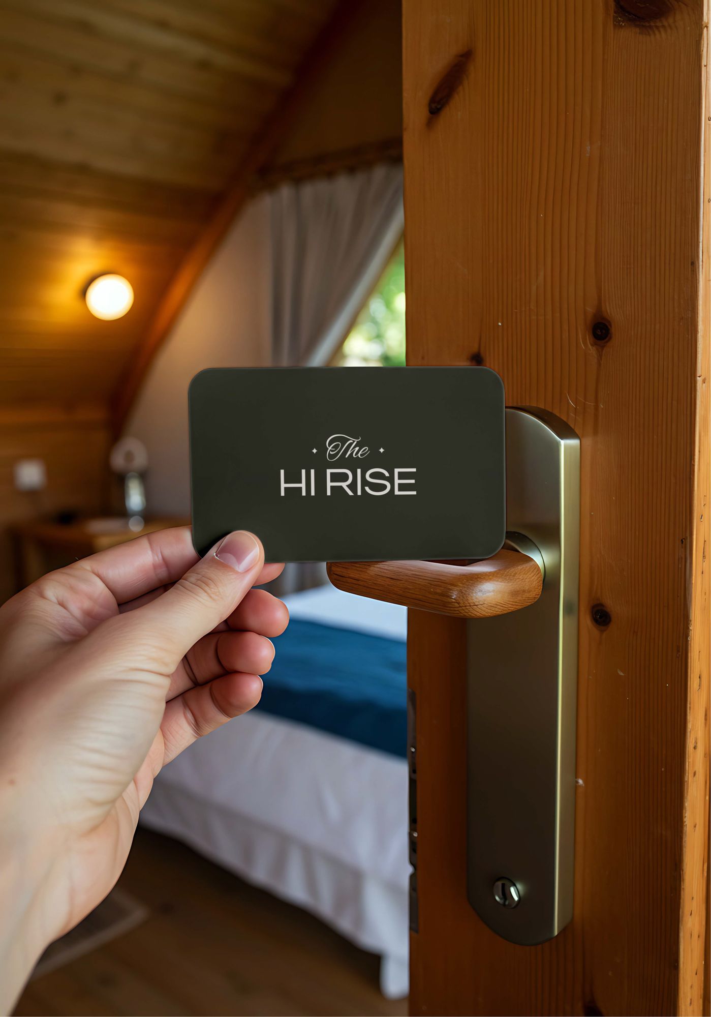 A hand holding an olive key card at a wooden door